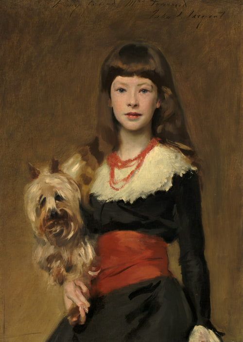 Young girl in black dress with red sash holds a terrier, gazing forward against a warm brown background.