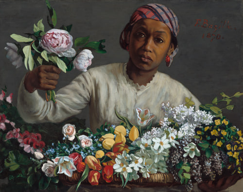 Woman with brown skin offers peonies over a large basket of colorful flowers, wearing a cream blouse and plaid headscarf, against gray background.